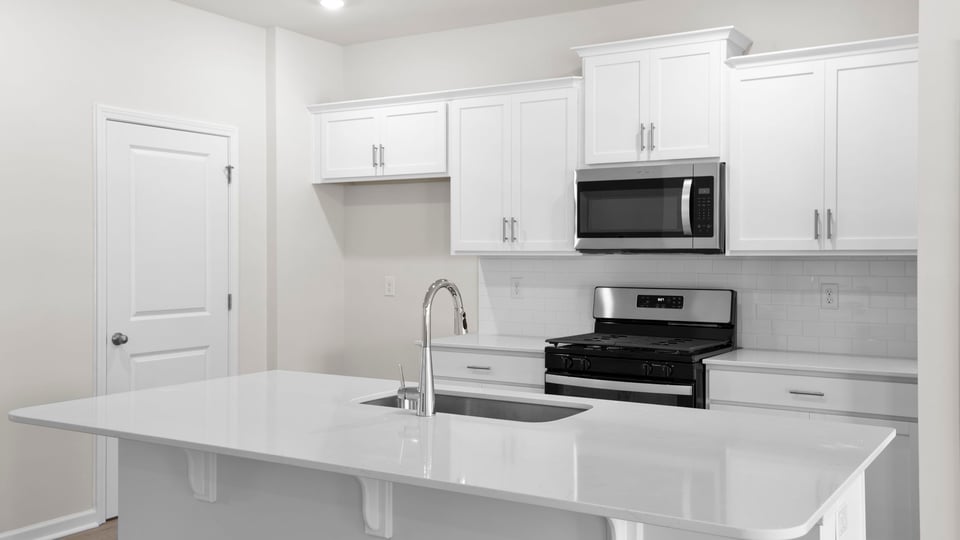 Kitchen with island and cabinets.
