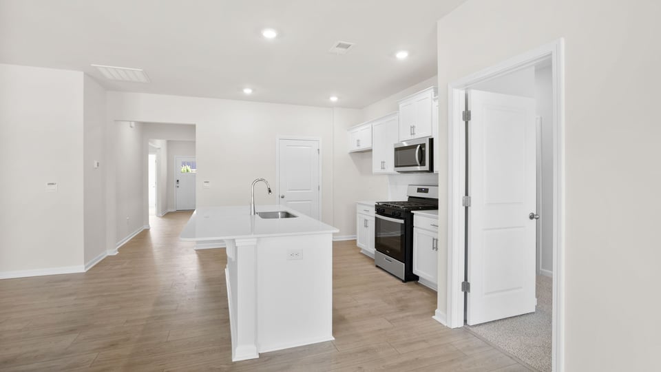 Kitchen with island and cabinets.