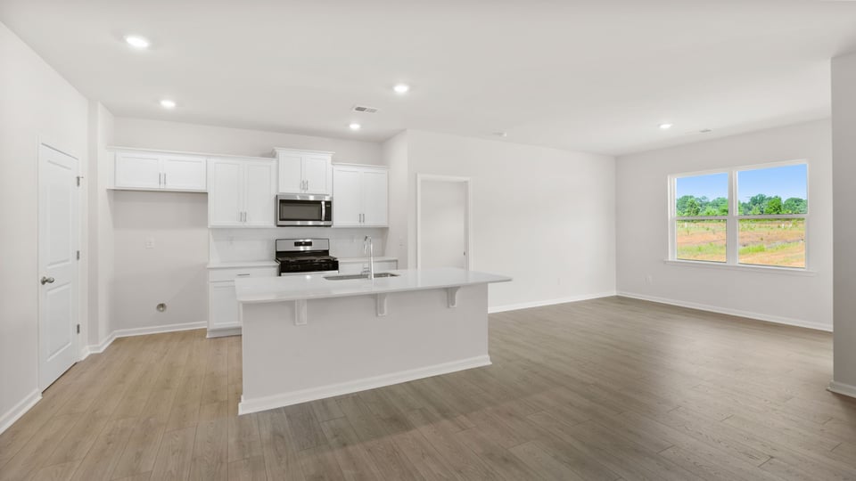 Kitchen with island and cabinets.
