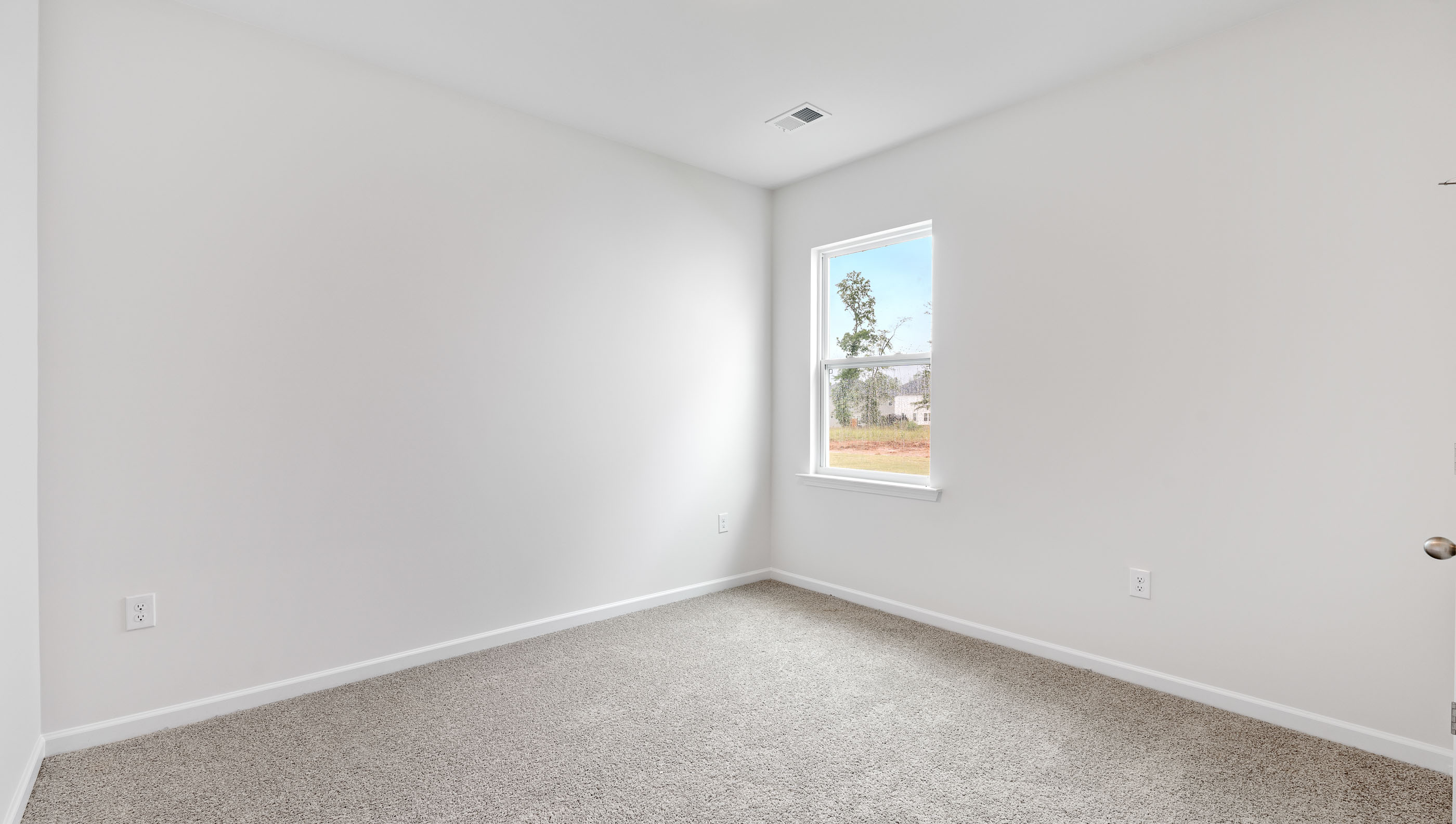 Bedroom with carpet and window.