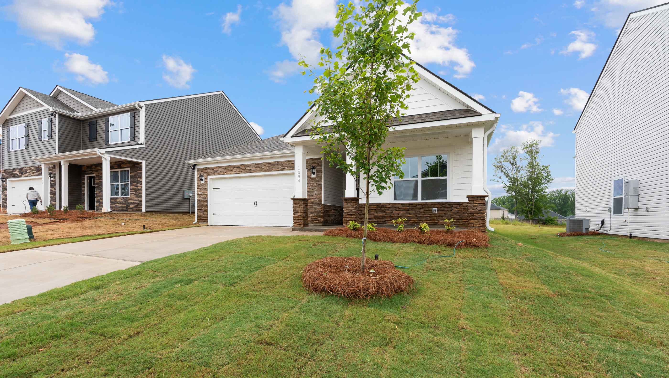 Front of Aria with 2 car garage.