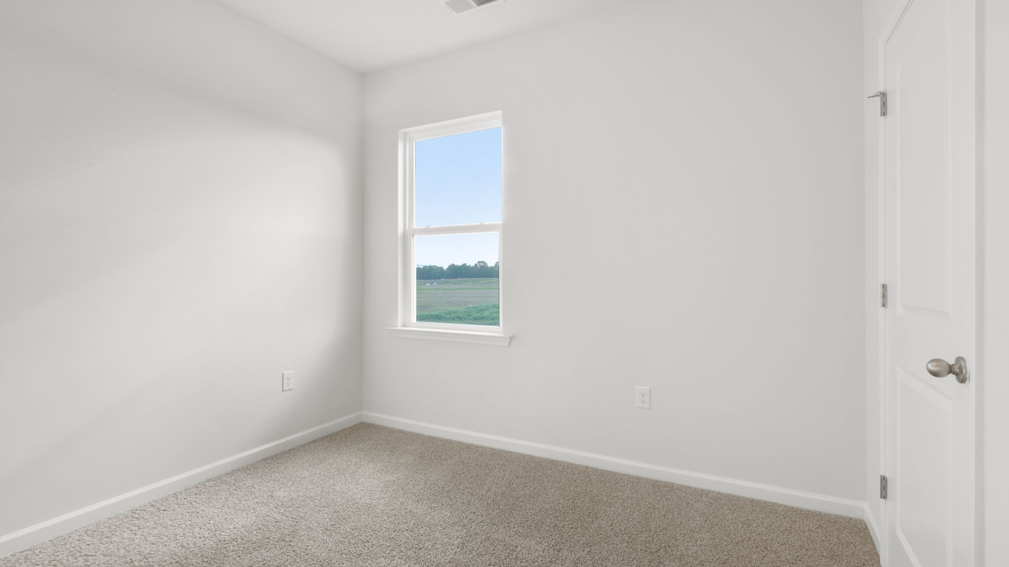 Bedroom with carpet and window.