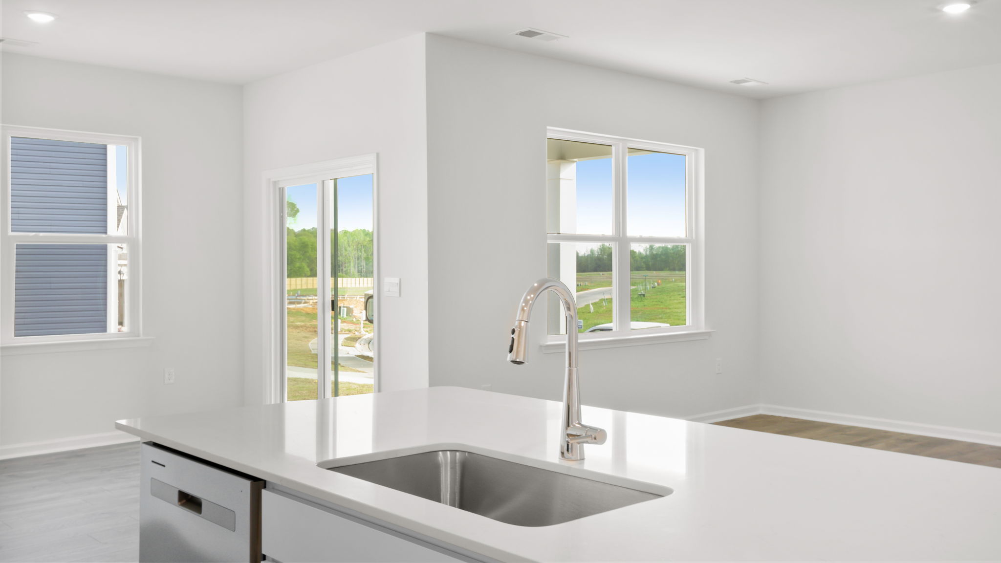 Kitchen and island with stainless steel appliances.