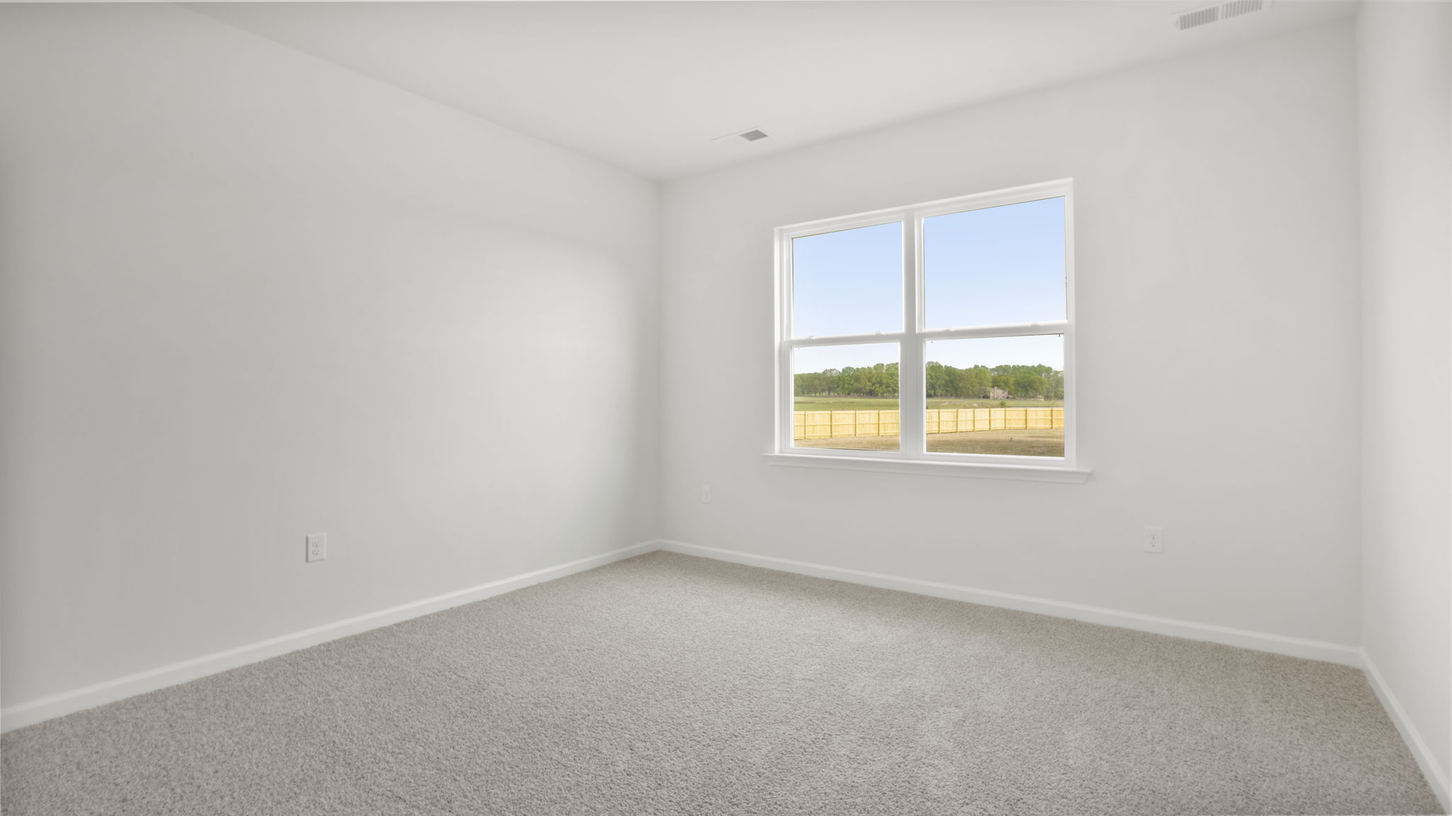 Bedroom with carpet and window.