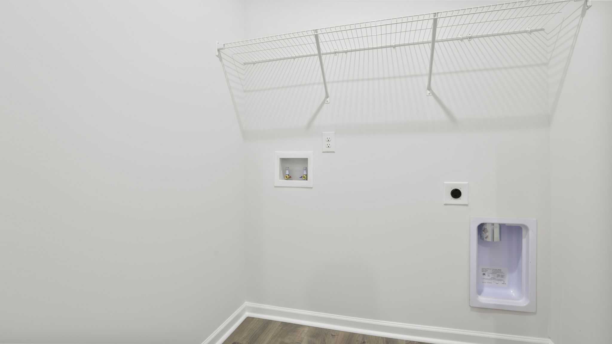 Laundry room with hanging storage racks.