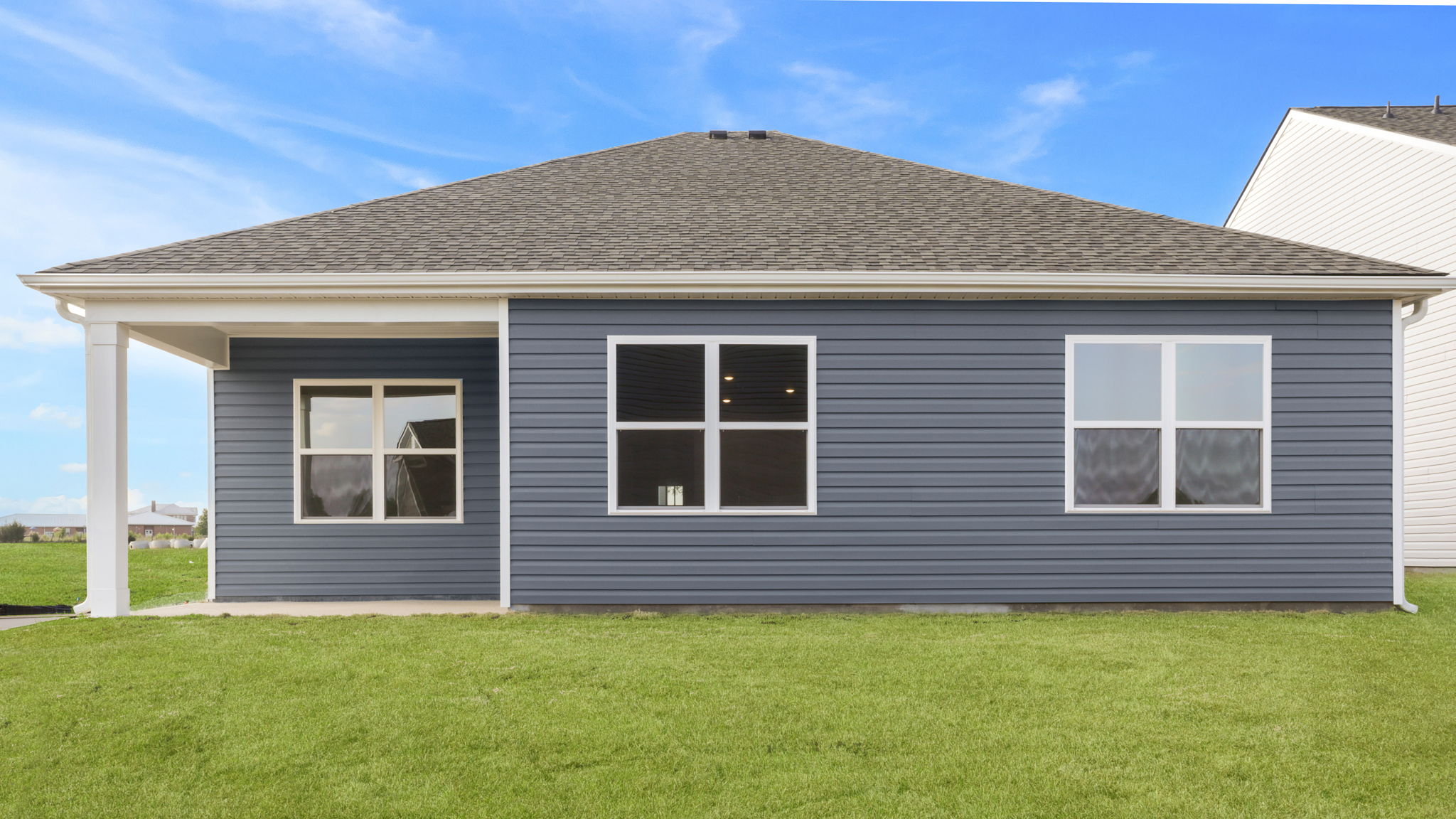 Back exterior of home with large backyard.