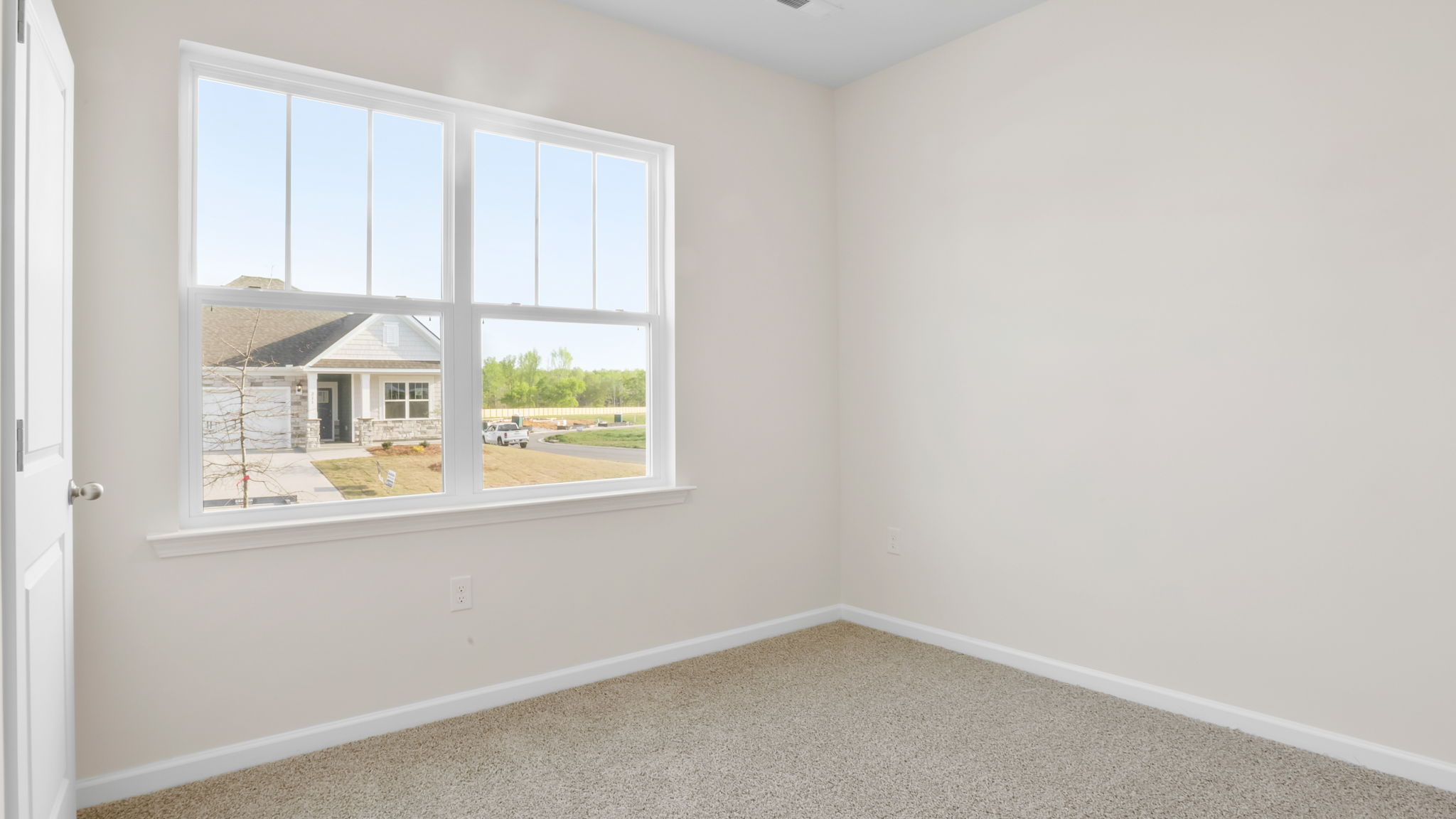 Bedroom with carpet and window.