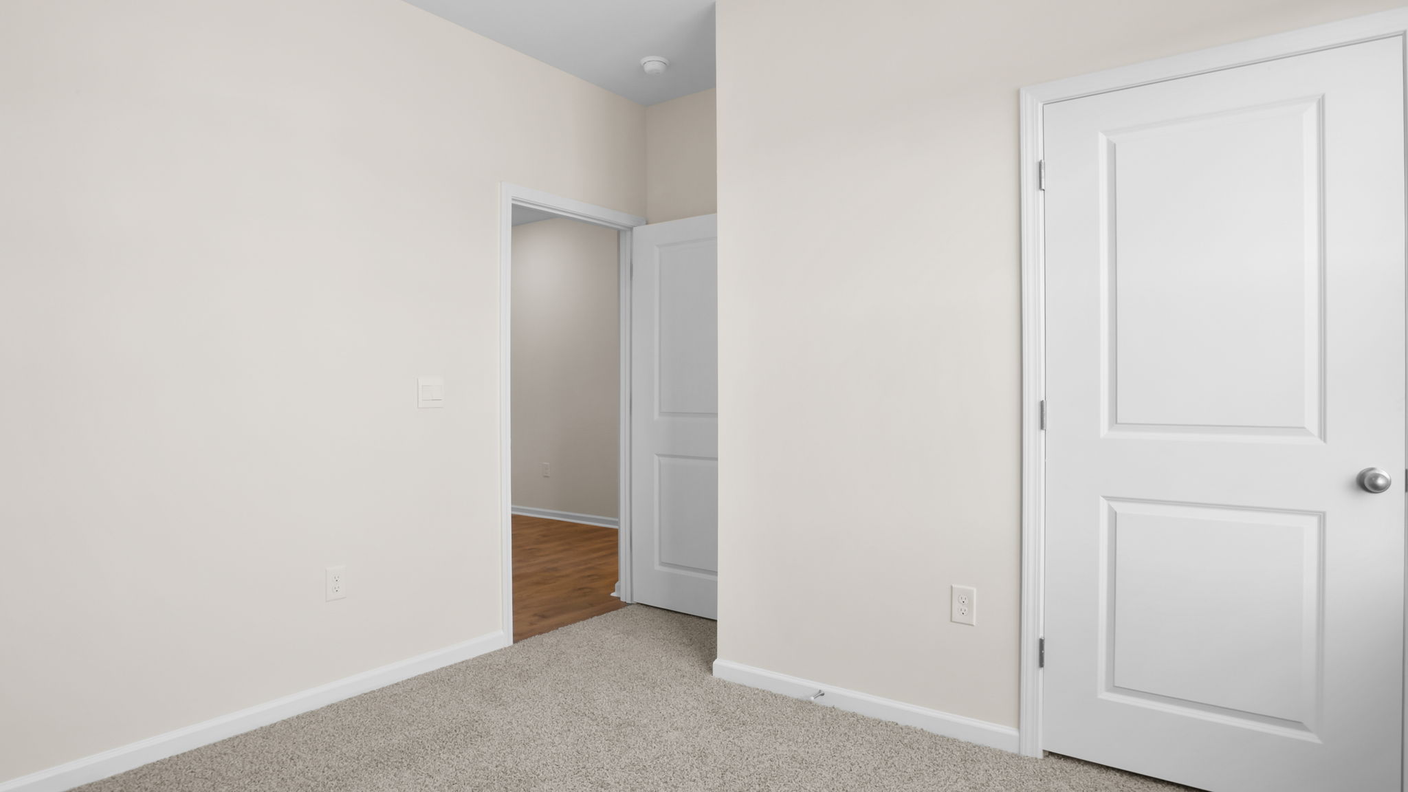 Bedroom with carpet and window.