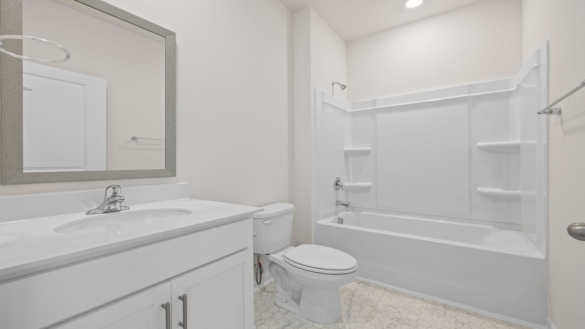 Hall bathroom with vanity and combination shower / tub.