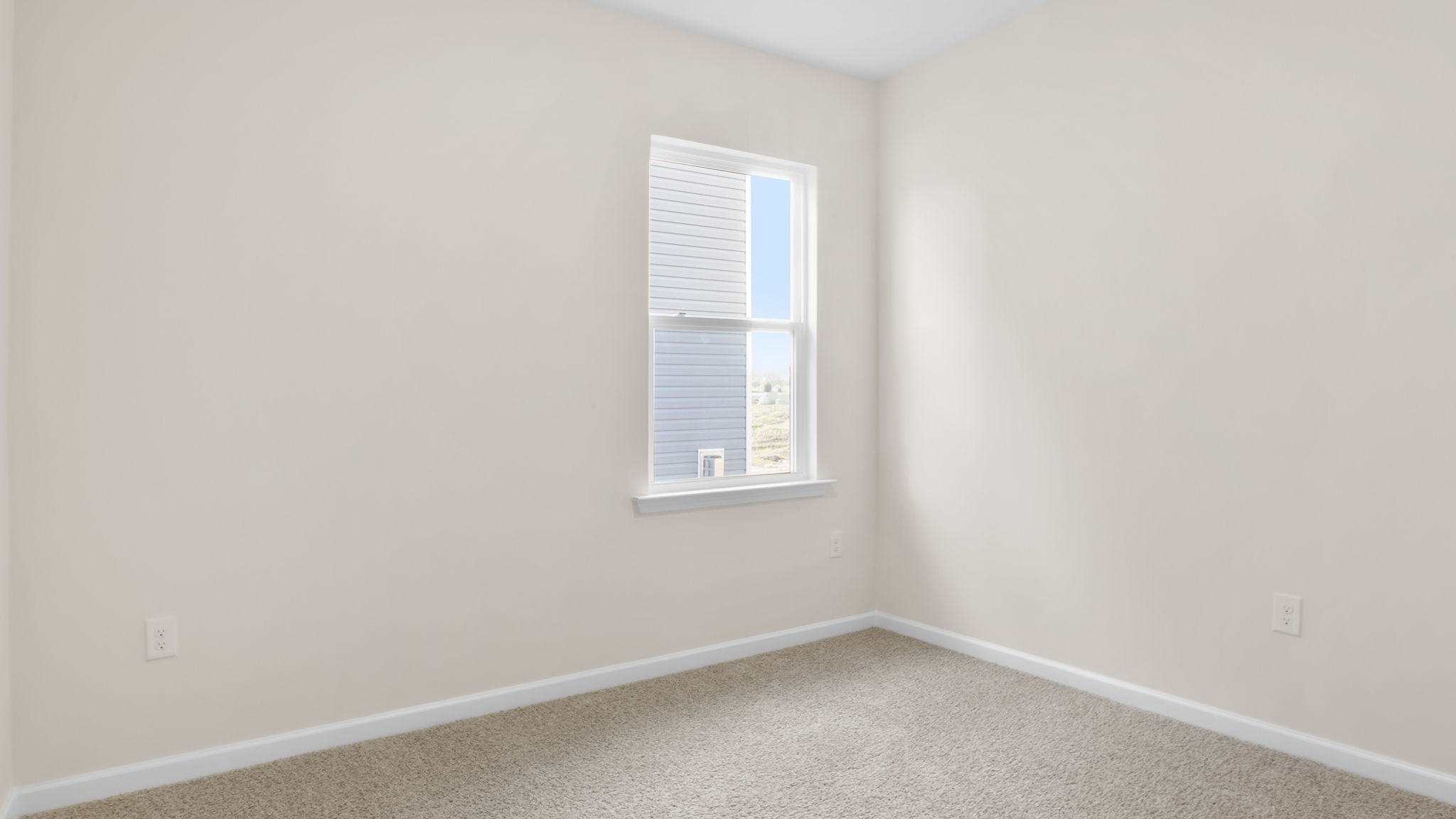 Bedroom with carpet and window.