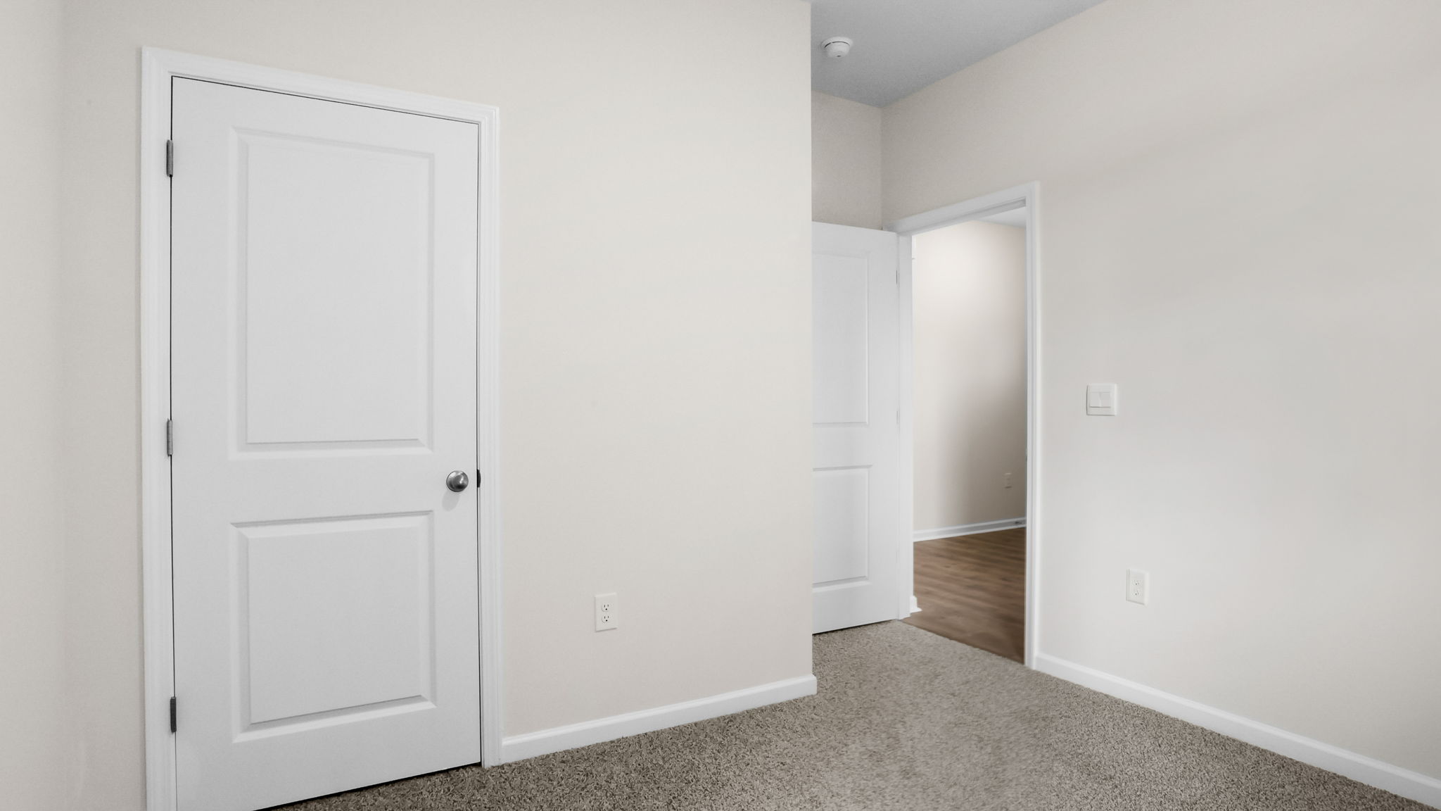 Bedroom with carpet and window.