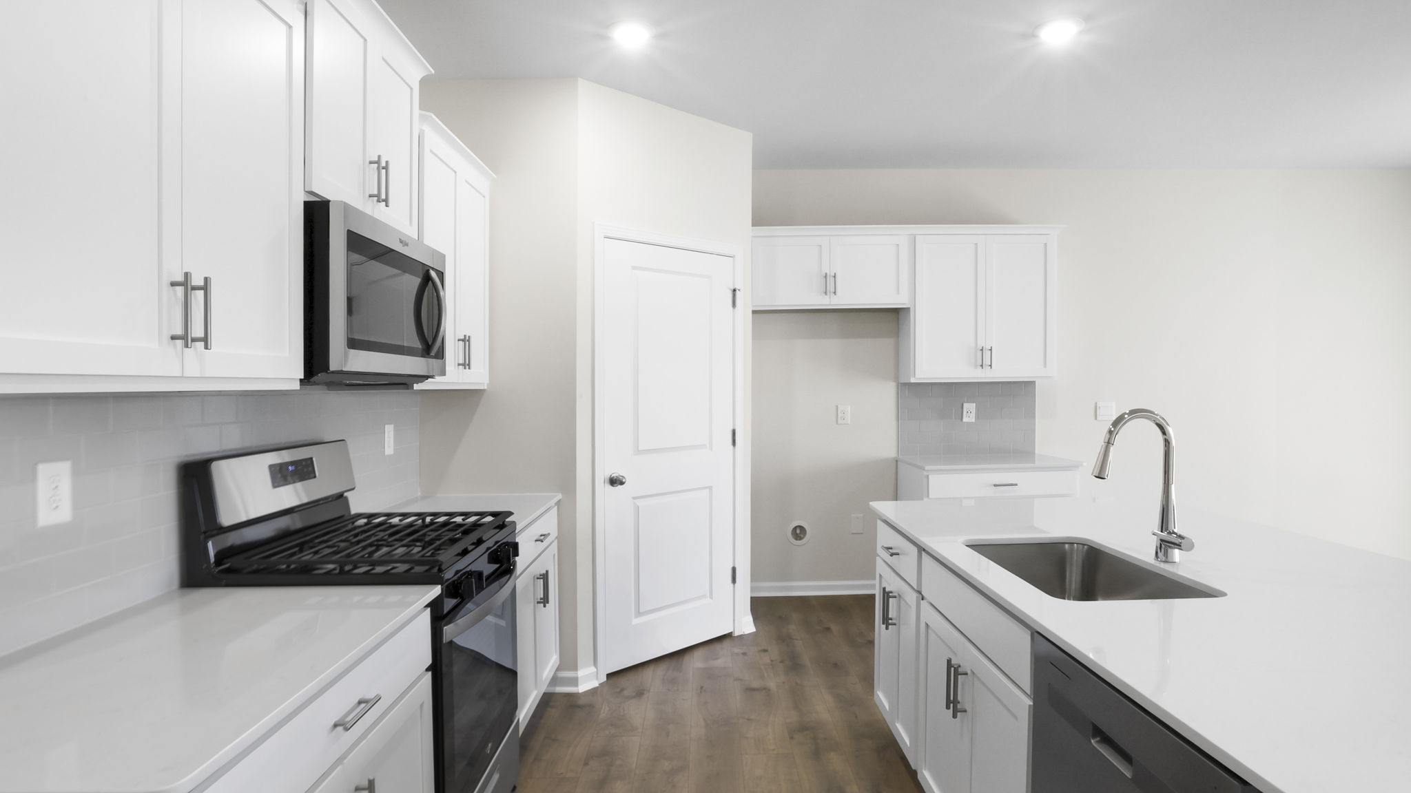 Kitchen and island with stainless steel appliances.