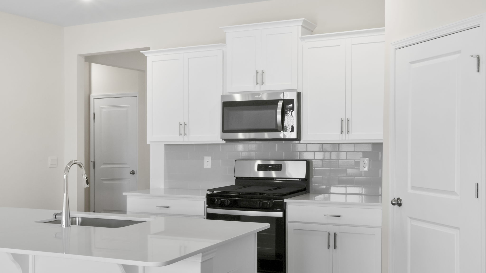 Kitchen and island with stainless steel appliances.