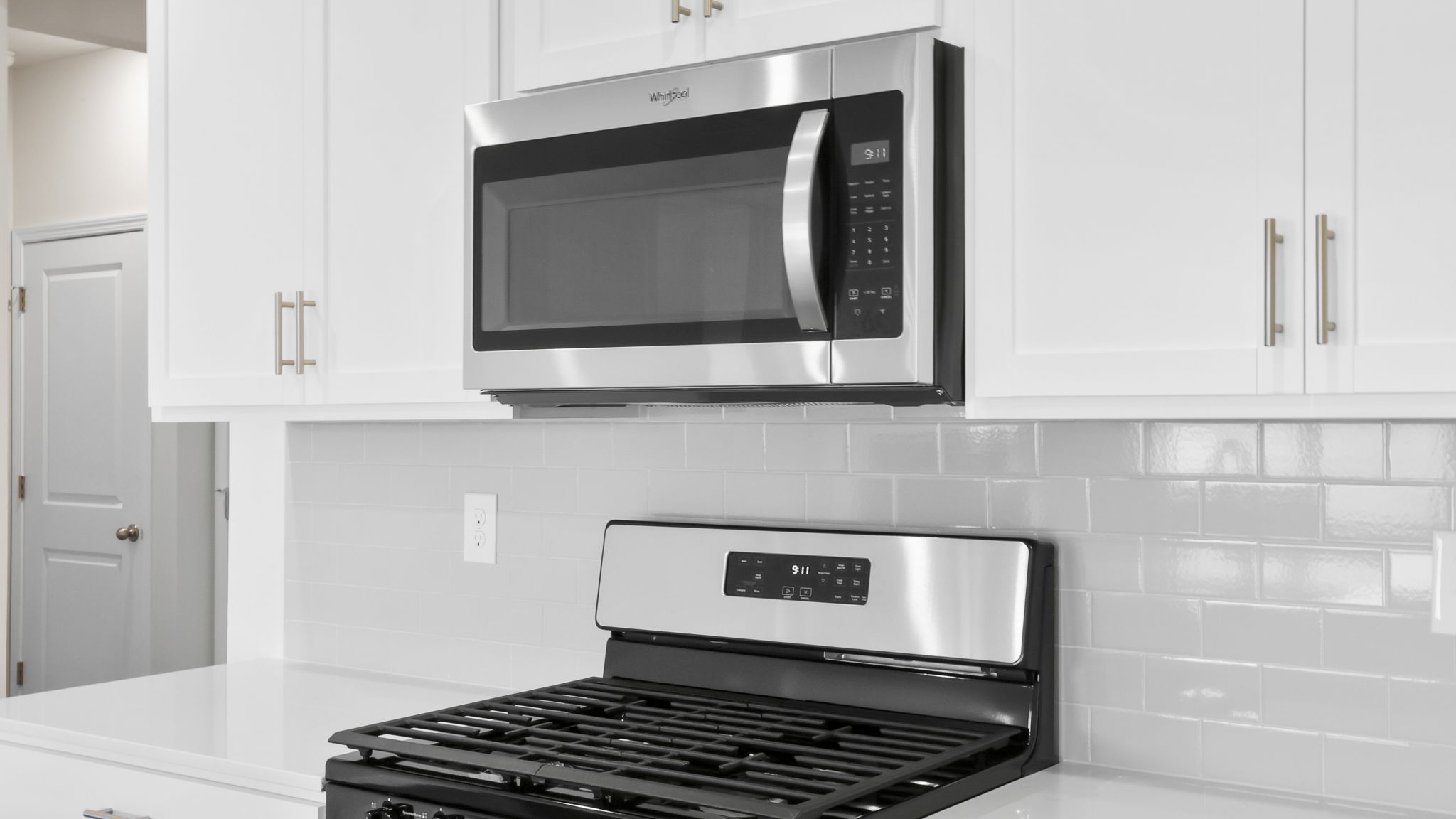 Kitchen and island with stainless steel appliances.
