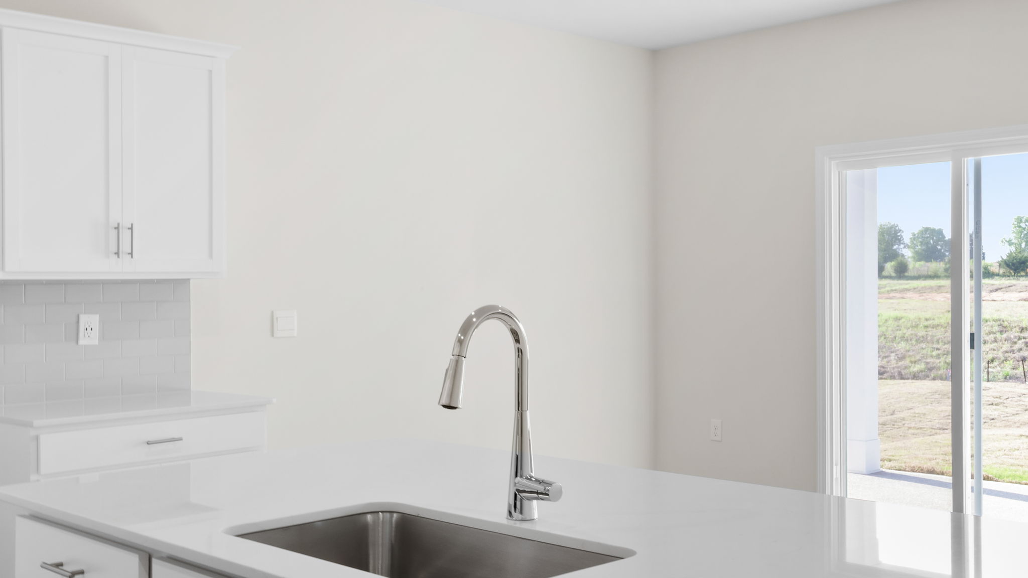 Kitchen and island with stainless steel appliances.