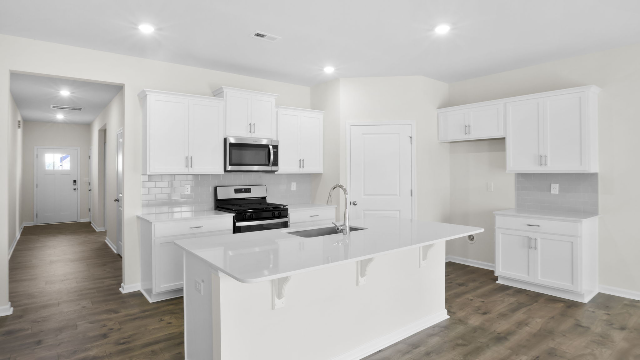 Kitchen and island with stainless steel appliances.