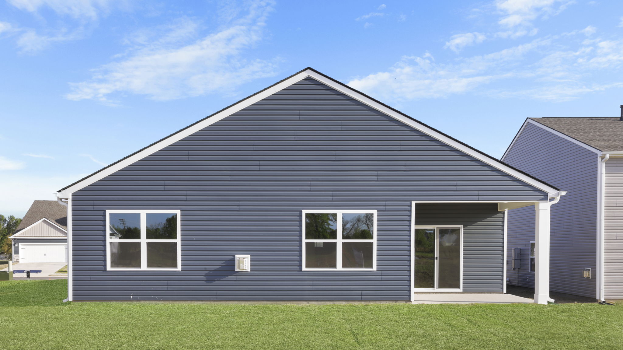 Back exterior of home with large backyard.