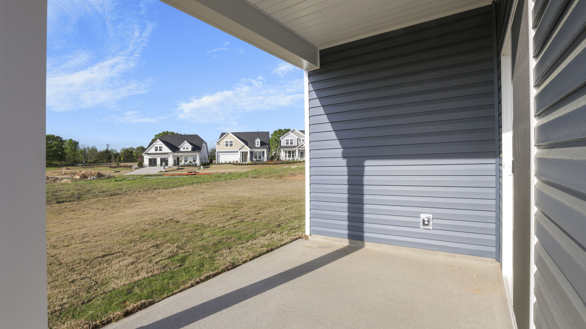 Back exterior of home with small patio.