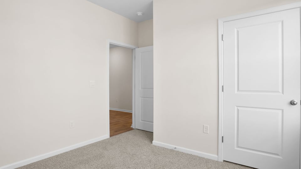 Bedroom with carpet and window