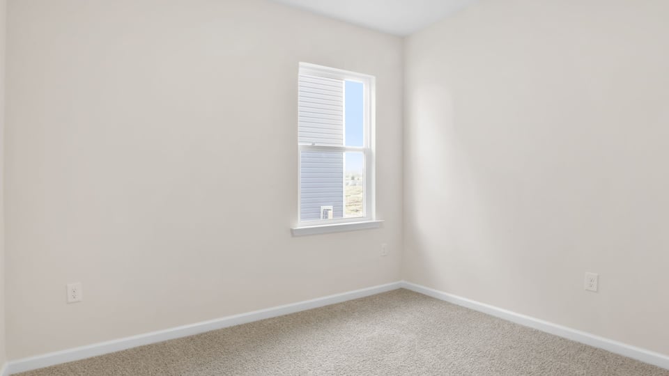 Bedroom with carpet and window