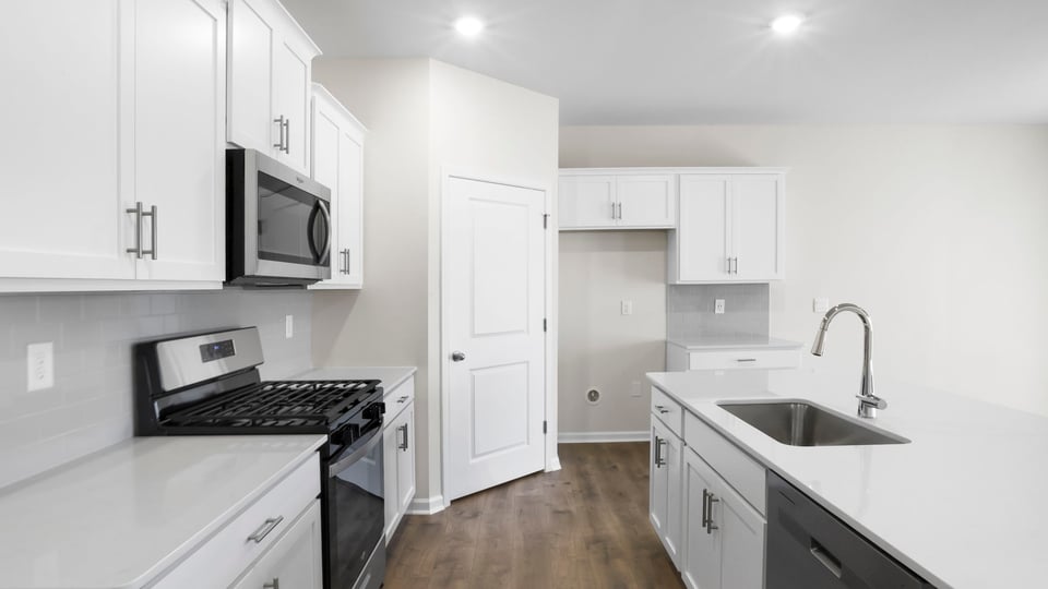Kitchen with island and cabinets.
