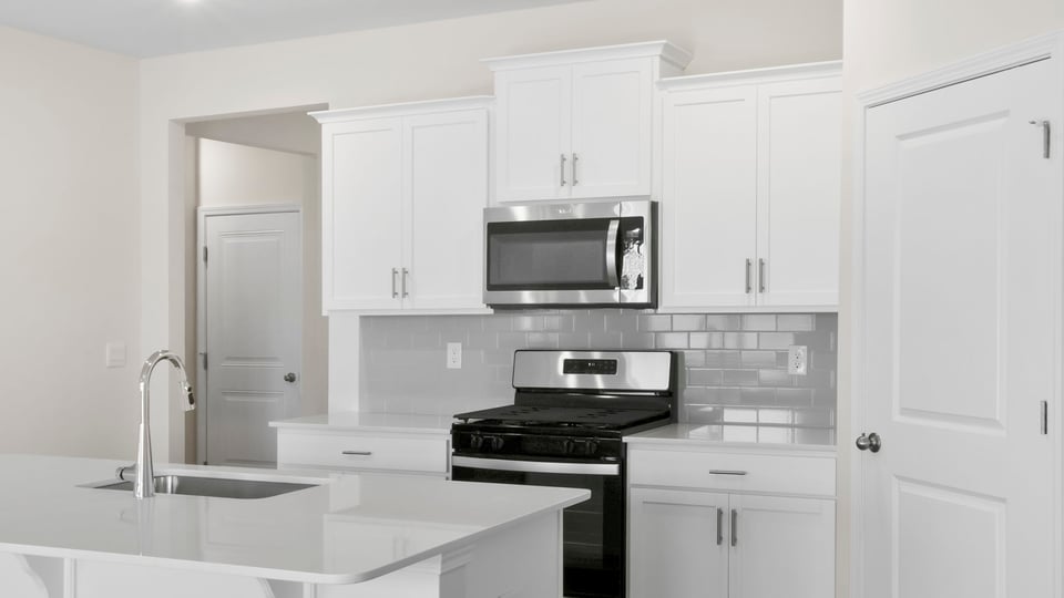 Kitchen with island and cabinets.