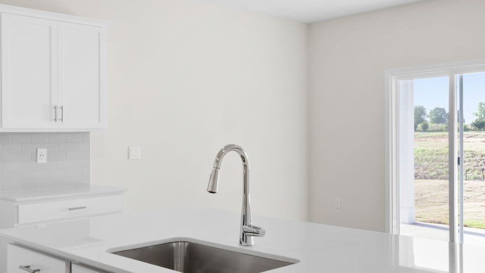 Kitchen with island and cabinets.
