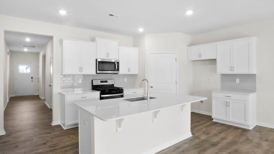 Kitchen with island and cabinets.