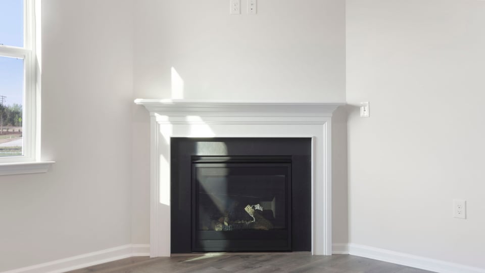 Living area with windows and fireplace.