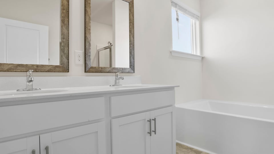 Primary bathroom with double vanity sinks.