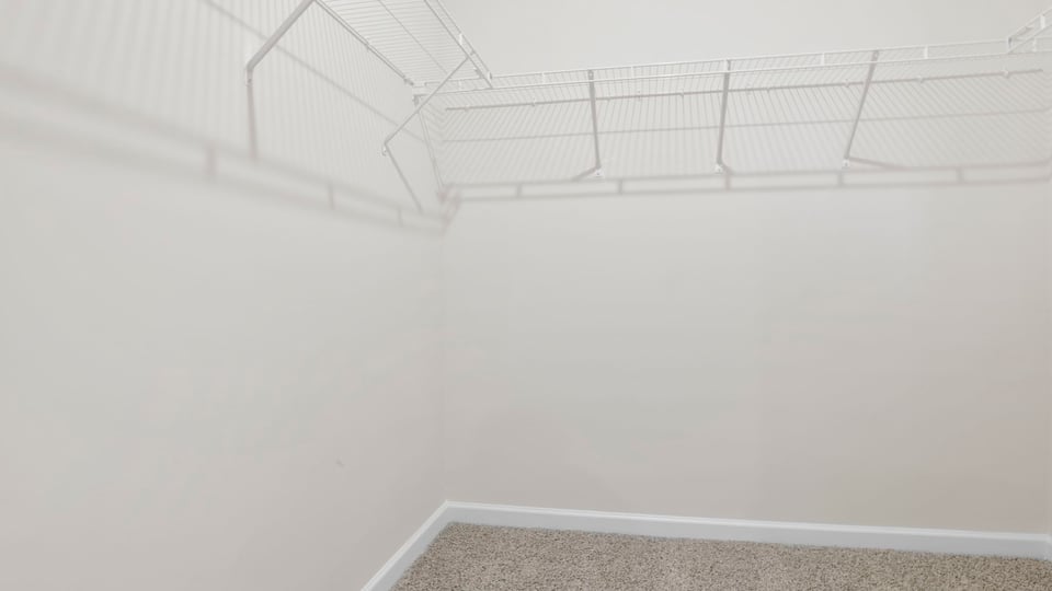 Primary closet with shelf.