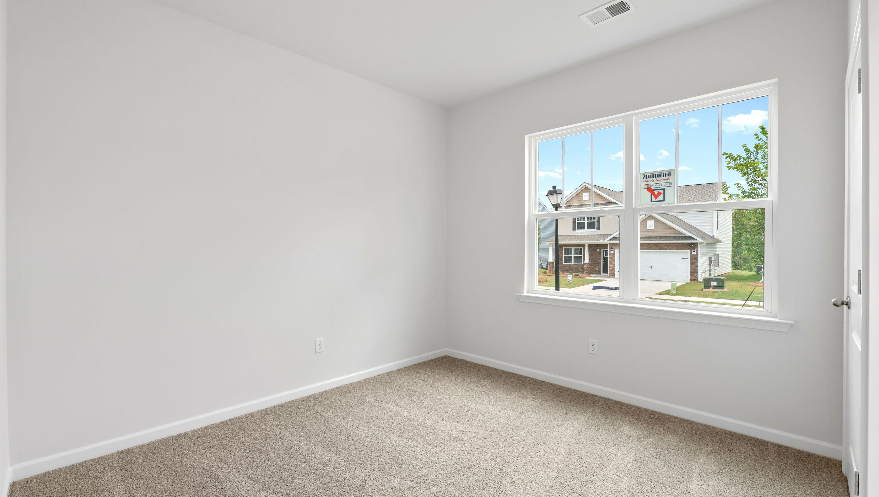 Bedroom with carpet and window.