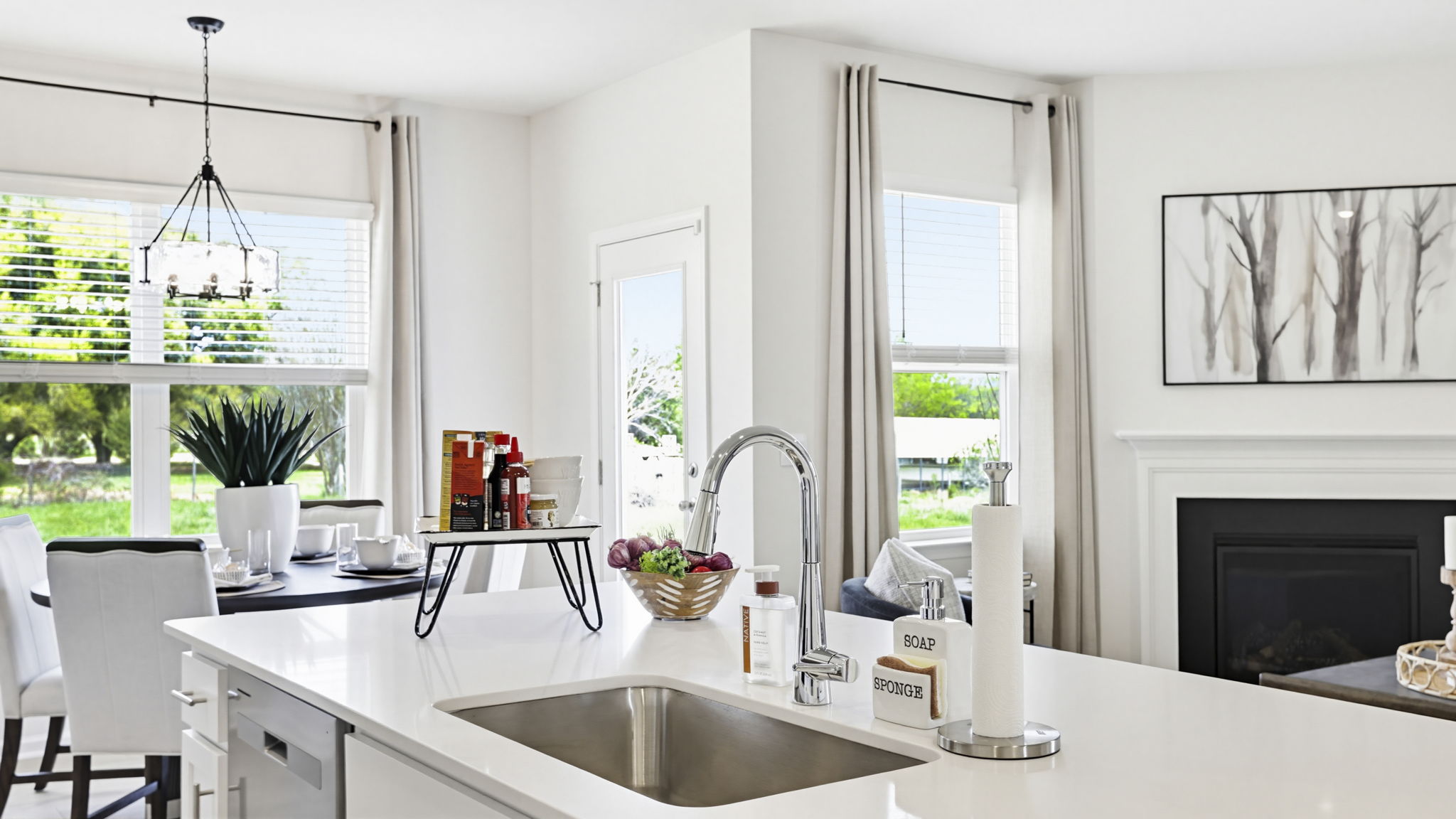 Kitchen and island with quartz countertops and stainless steel appliances.