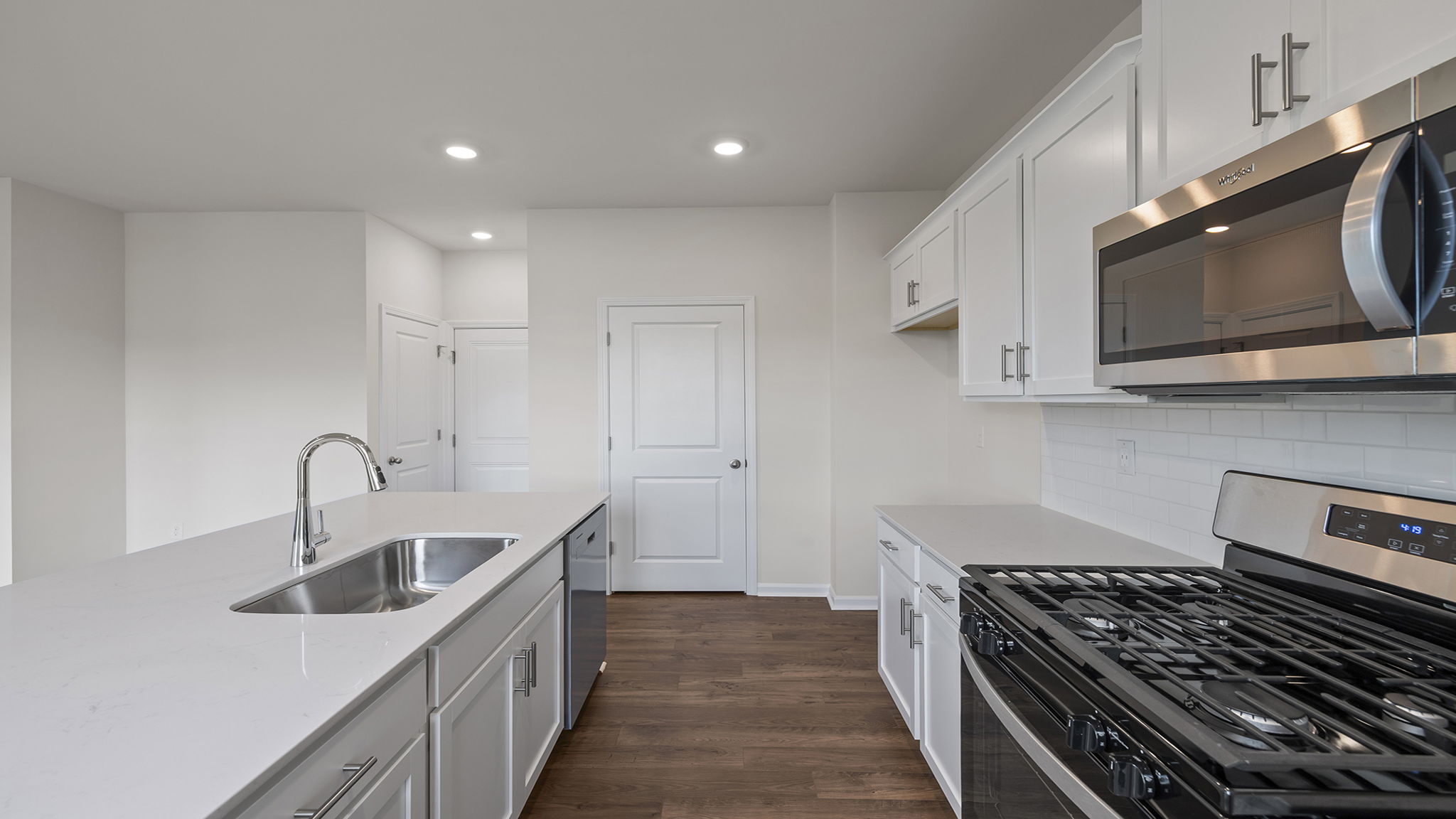 Kitchen with island and cabinets.
