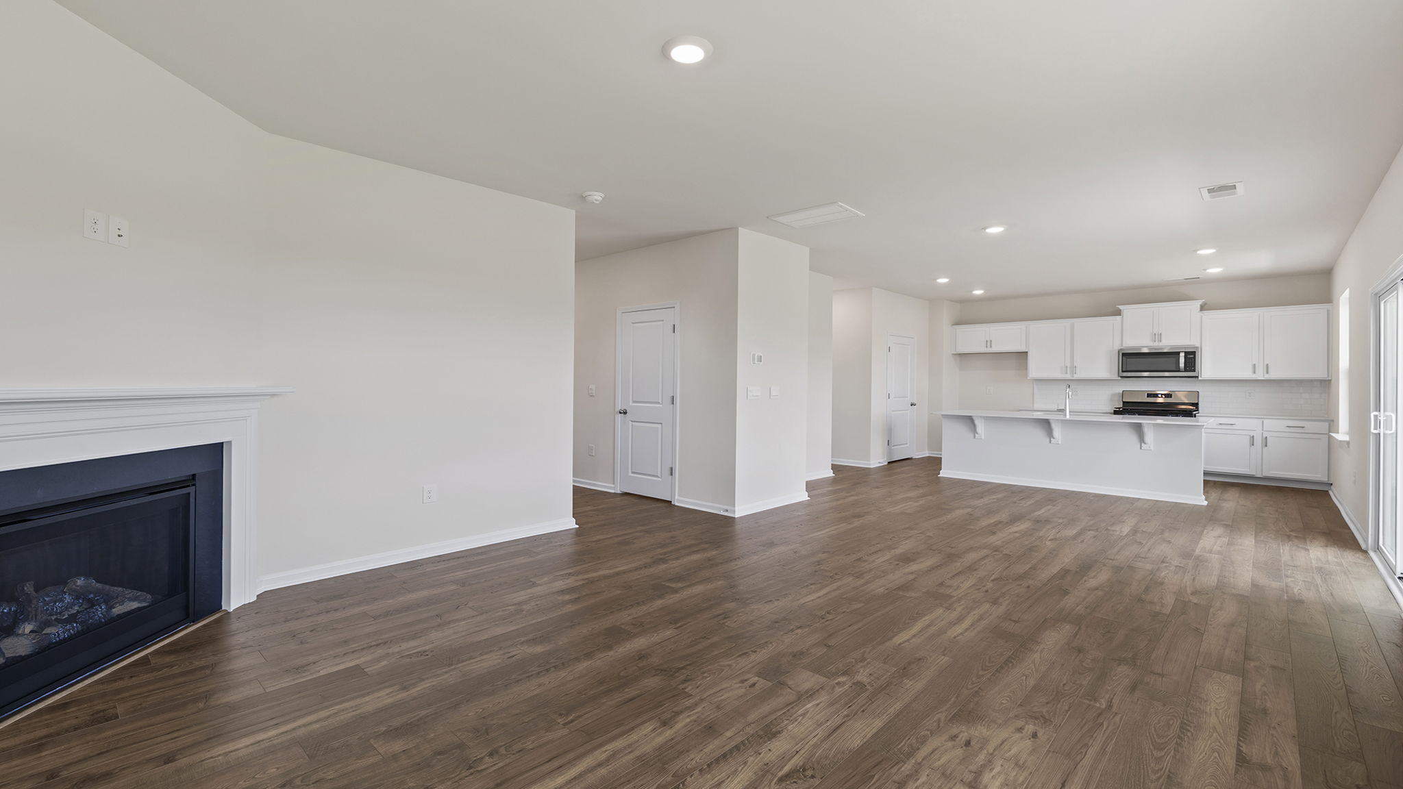 Living area with fireplace and windows.