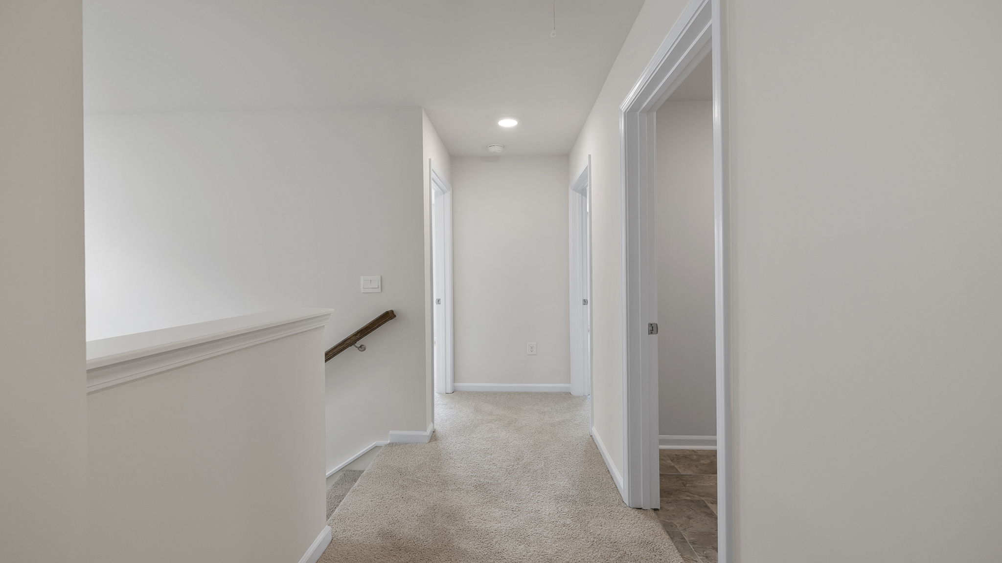 Top of stairs with carpet.