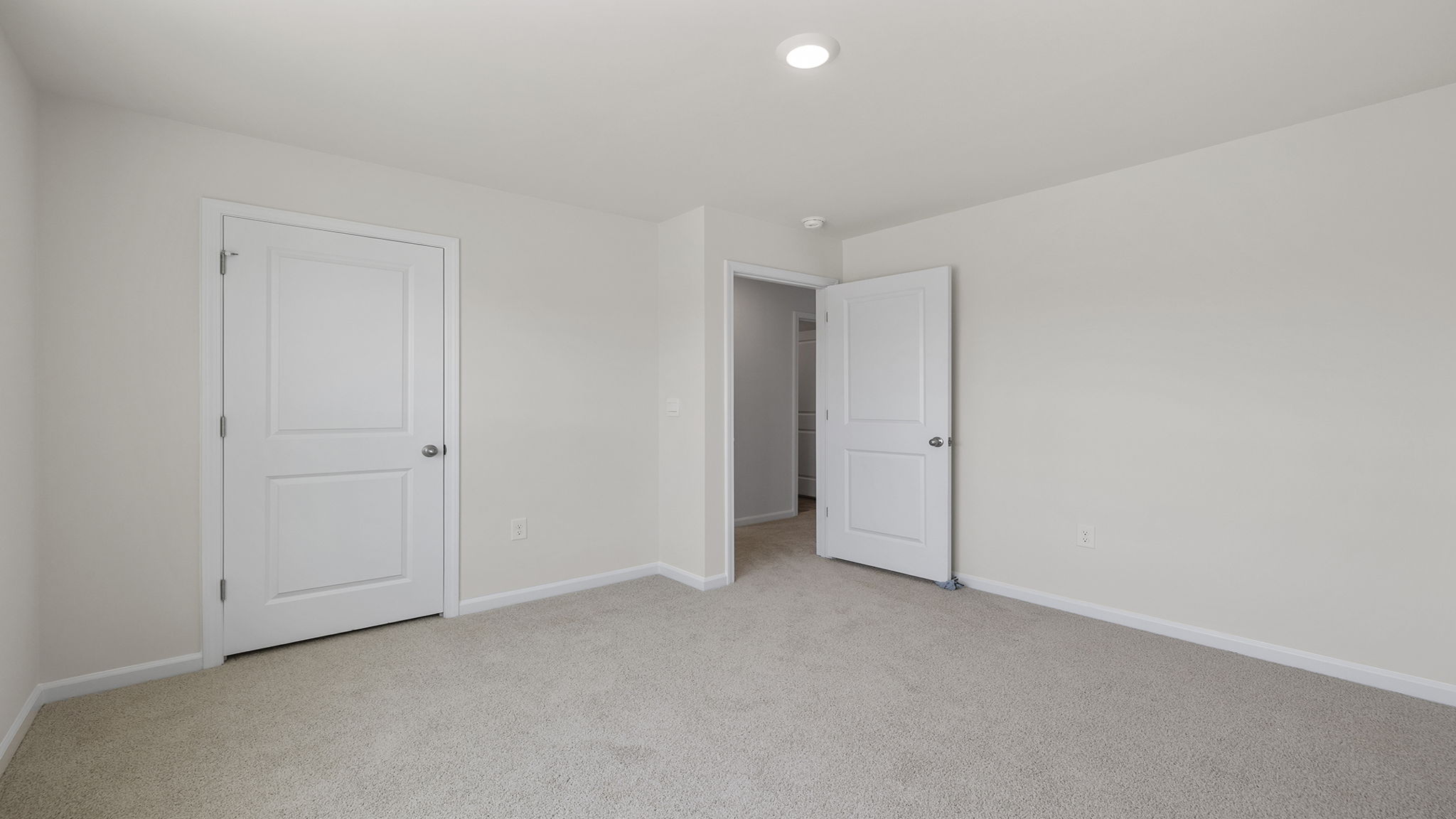 Bedroom with carpet and window.
