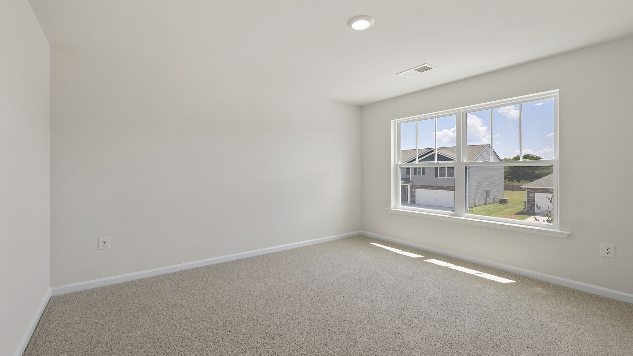 Bedroom with carpet and window.