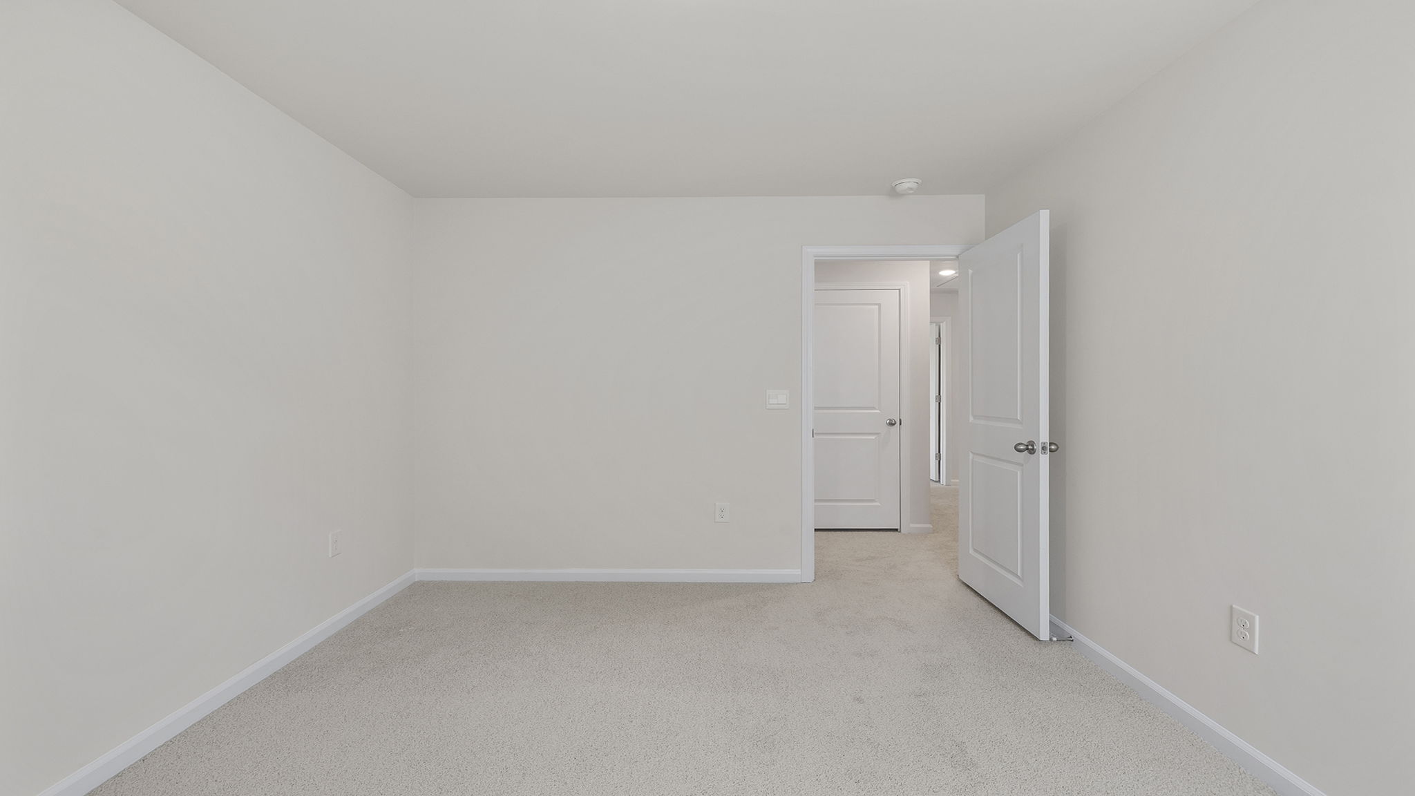 Bedroom with carpet and window.