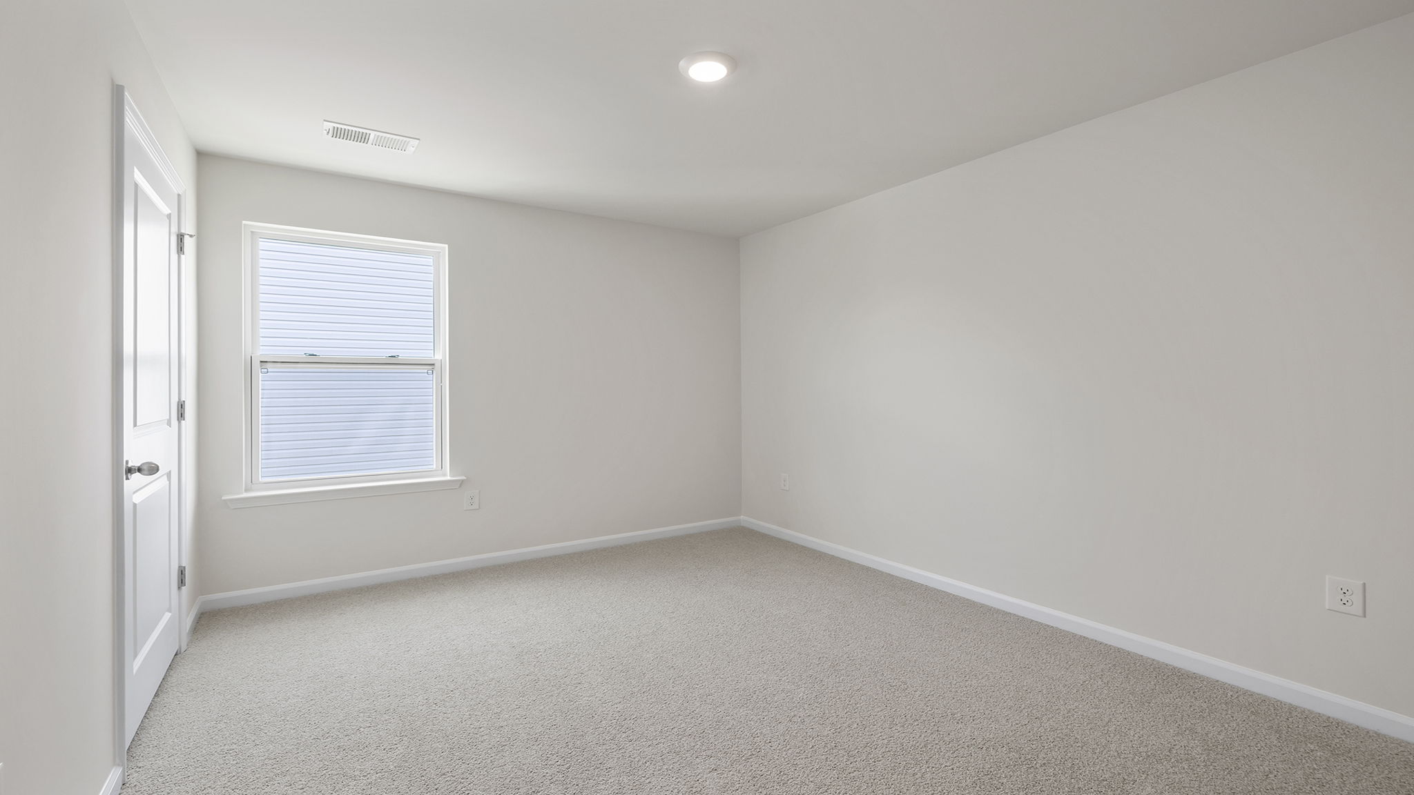 Bedroom with carpet and window.