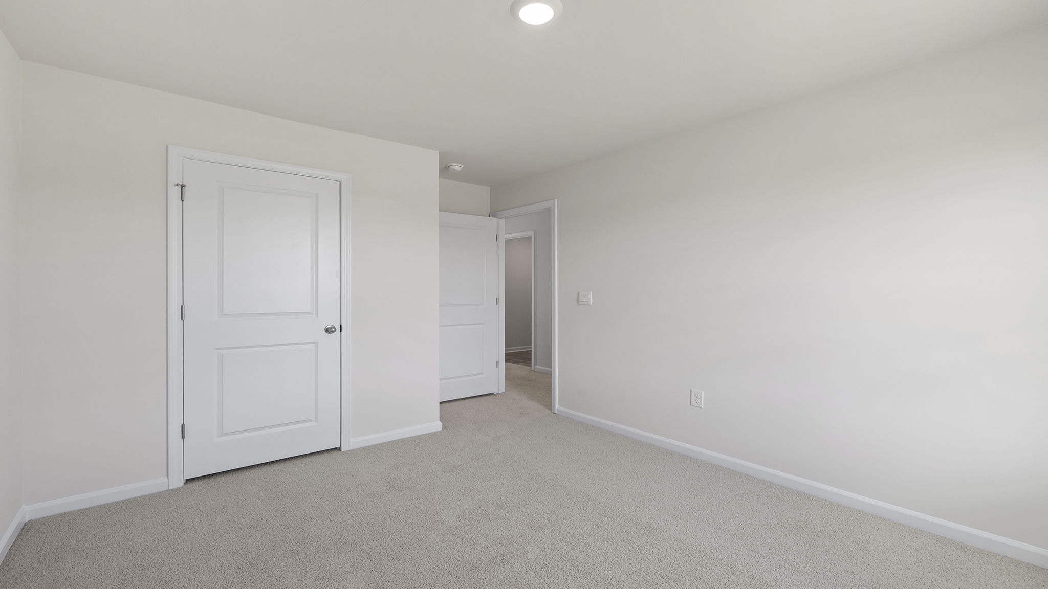 Bedroom with carpet and window.
