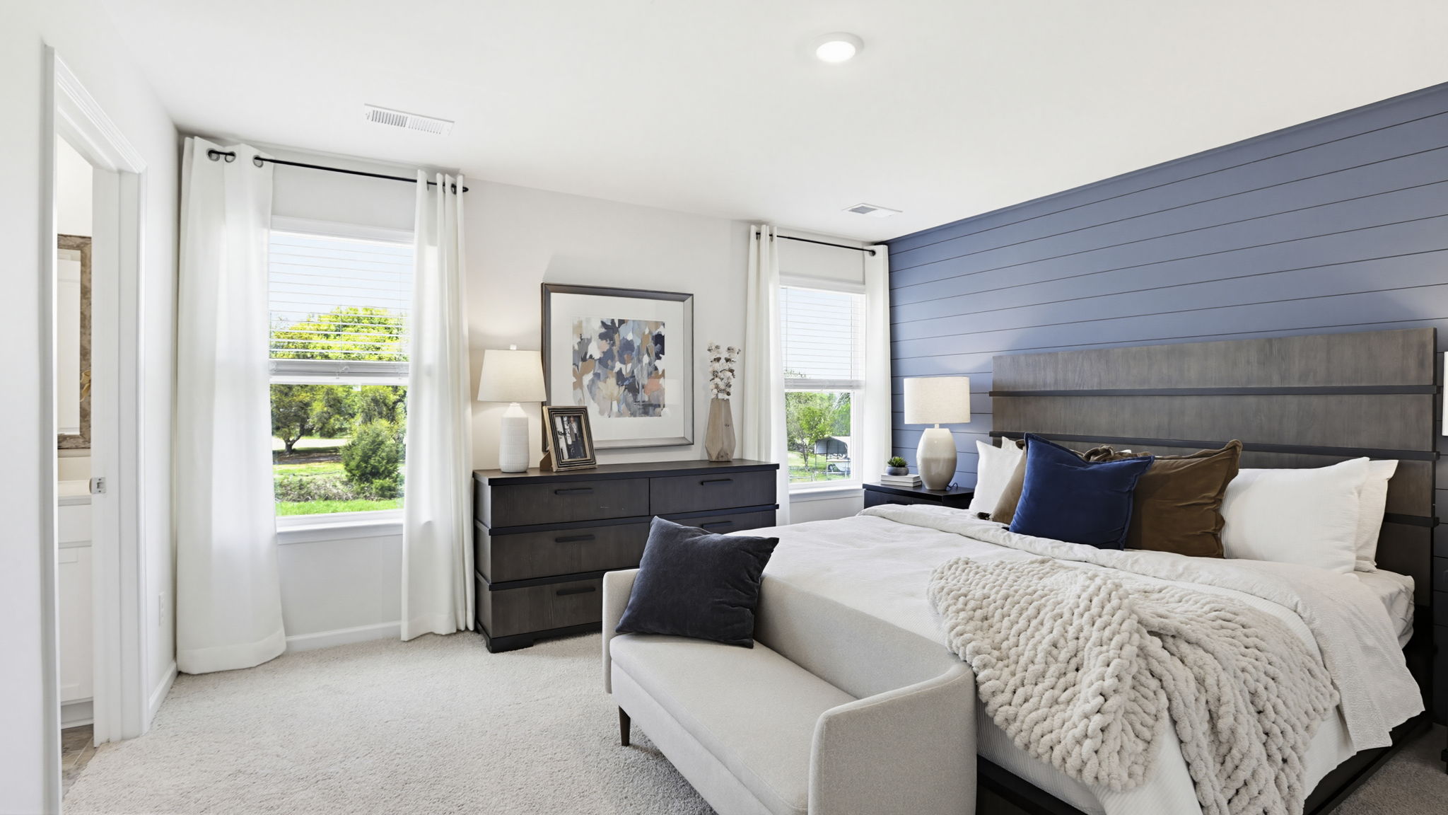 Bedroom with carpet and window on main floor.