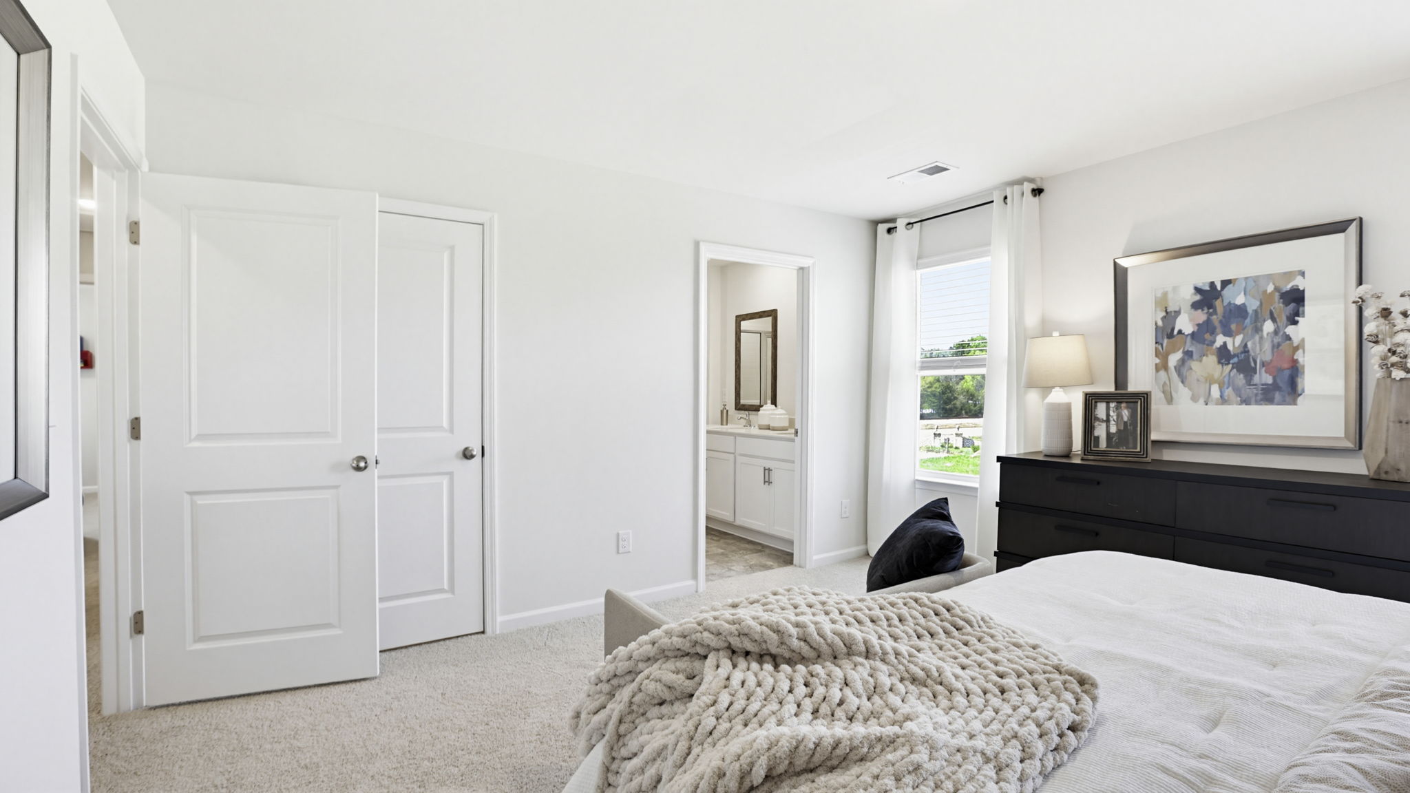 Bedroom with carpet and window on main floor.
