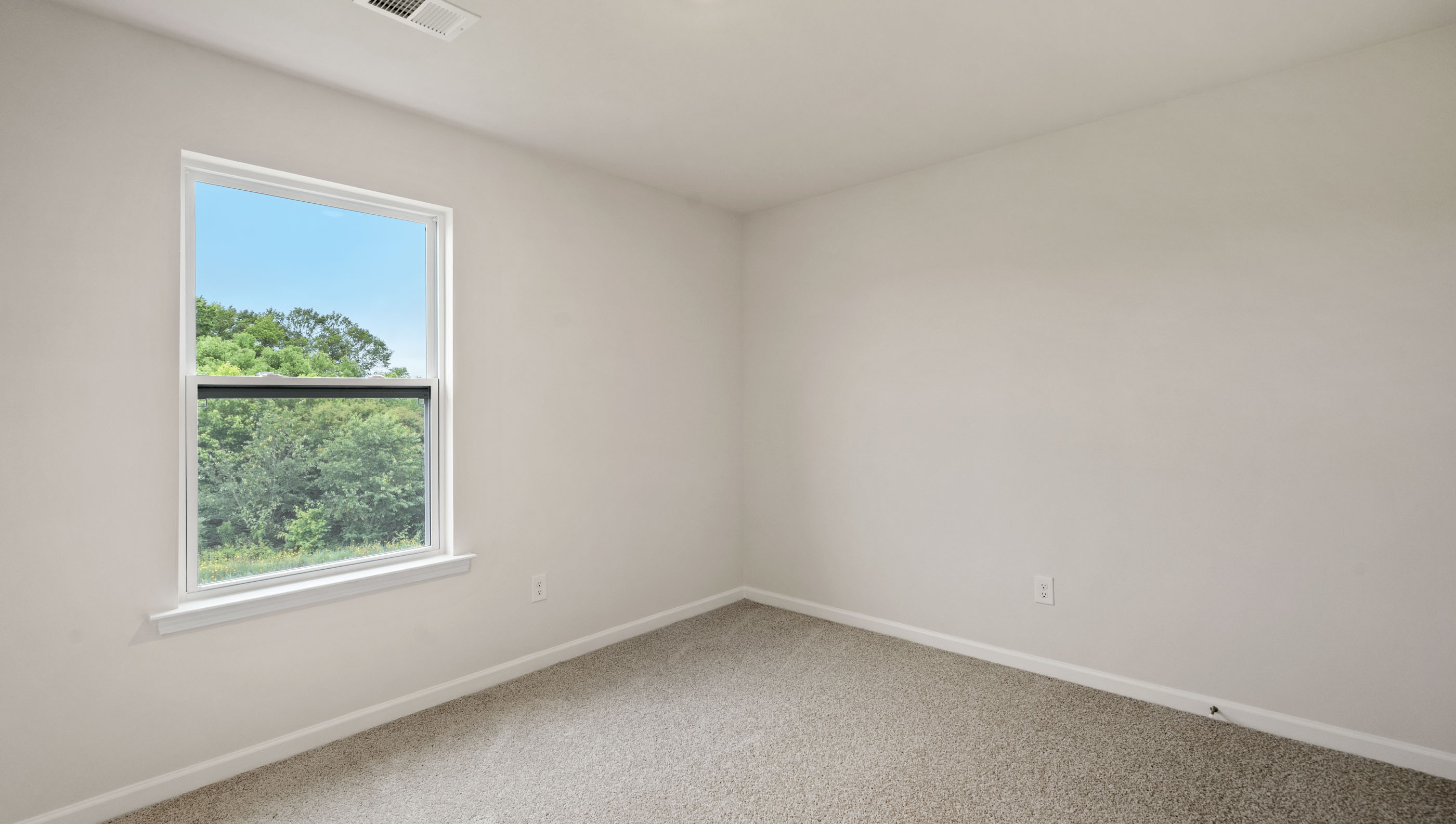 Bedroom with carpet and window.