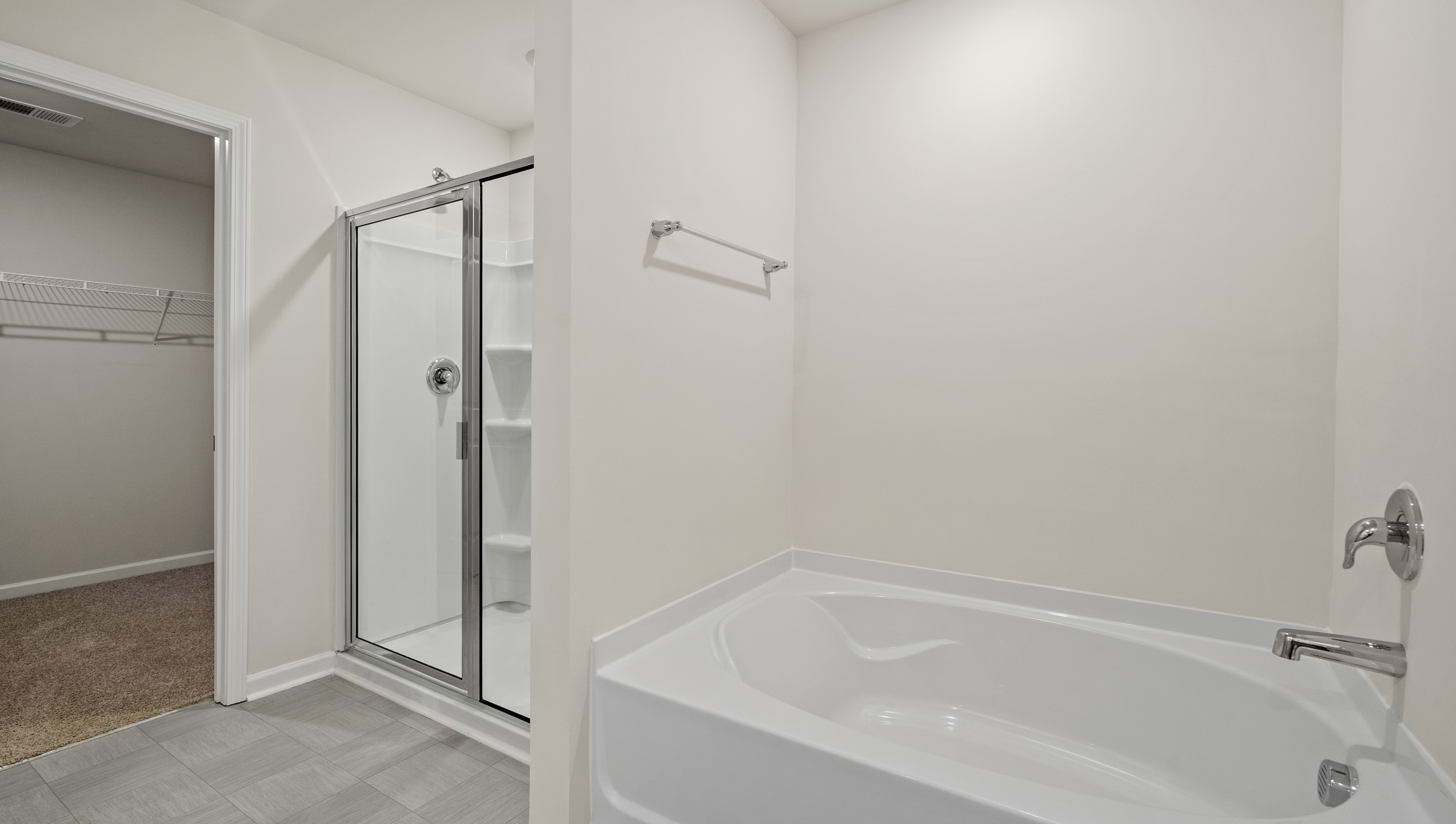 Primary bathroom with bathtub and walk in shower.