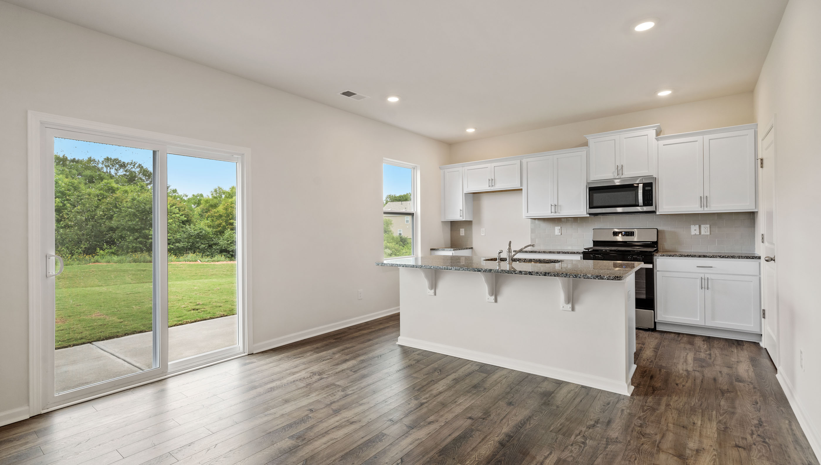 Kitchen and island with quartz counter tops.