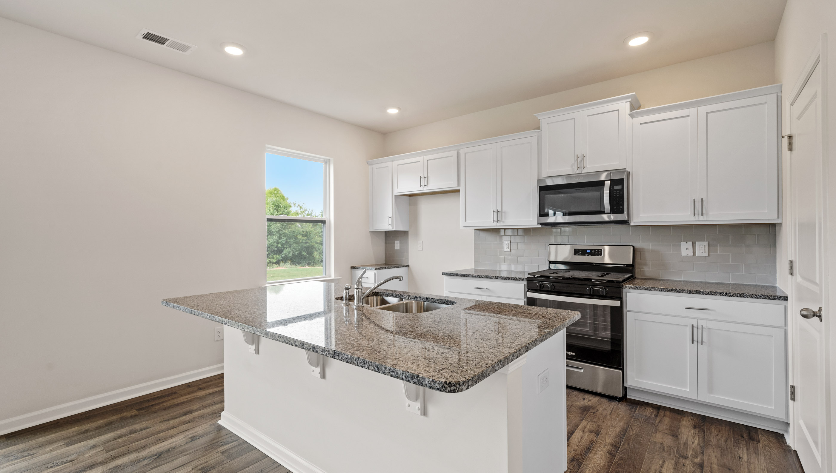 Kitchen with stainless steel appliances and walk in pantry.
