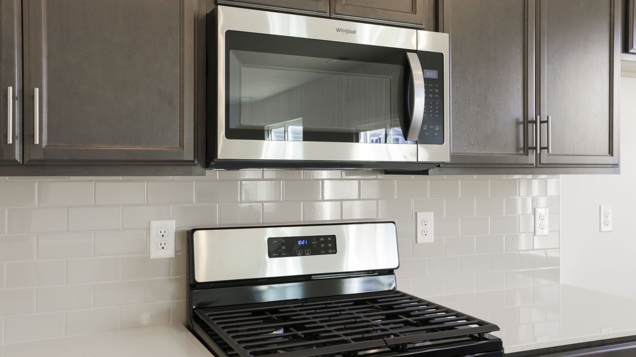 Kitchen and island with stainless steel appliances.