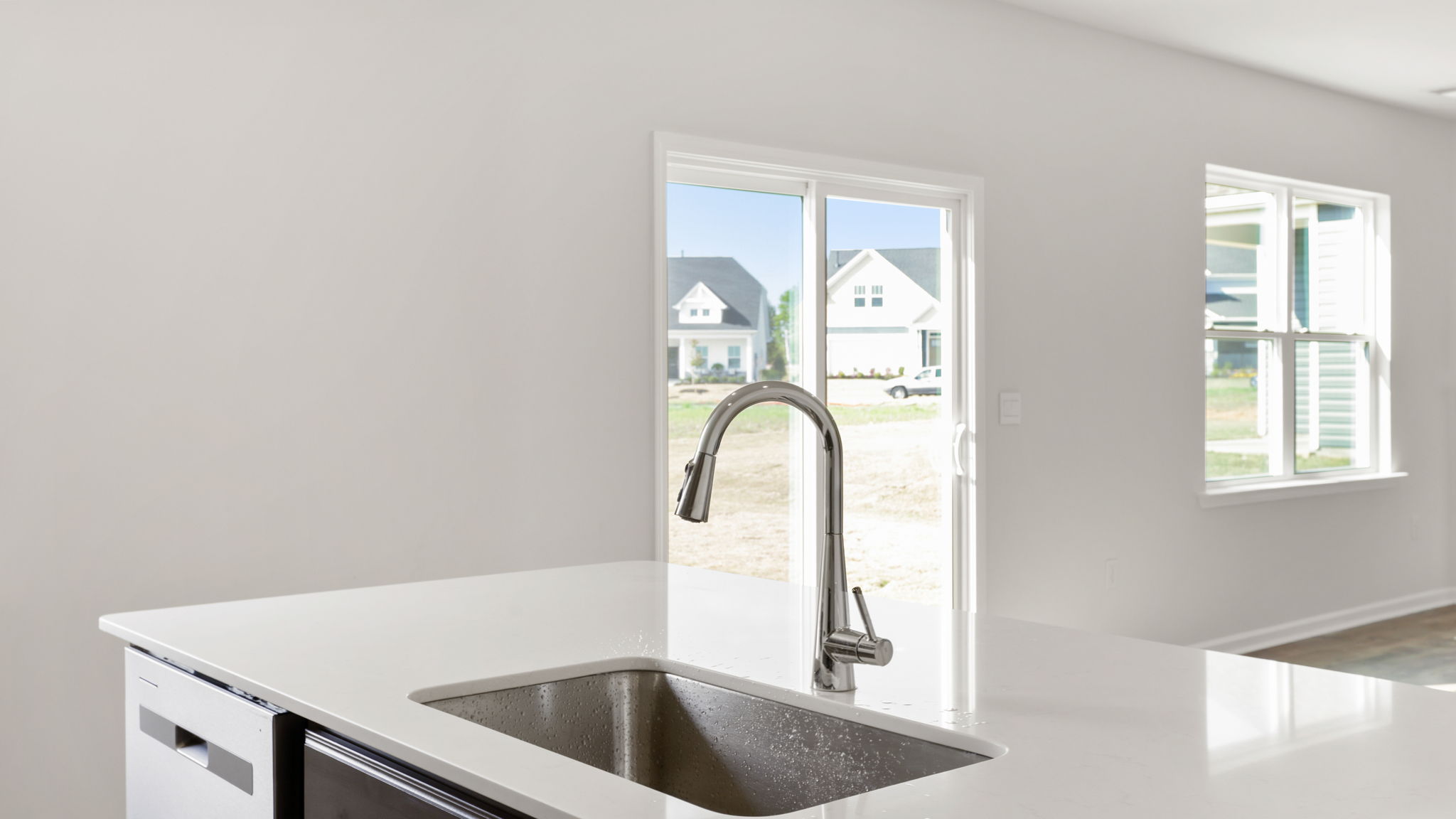 Kitchen and island with stainless steel appliances.