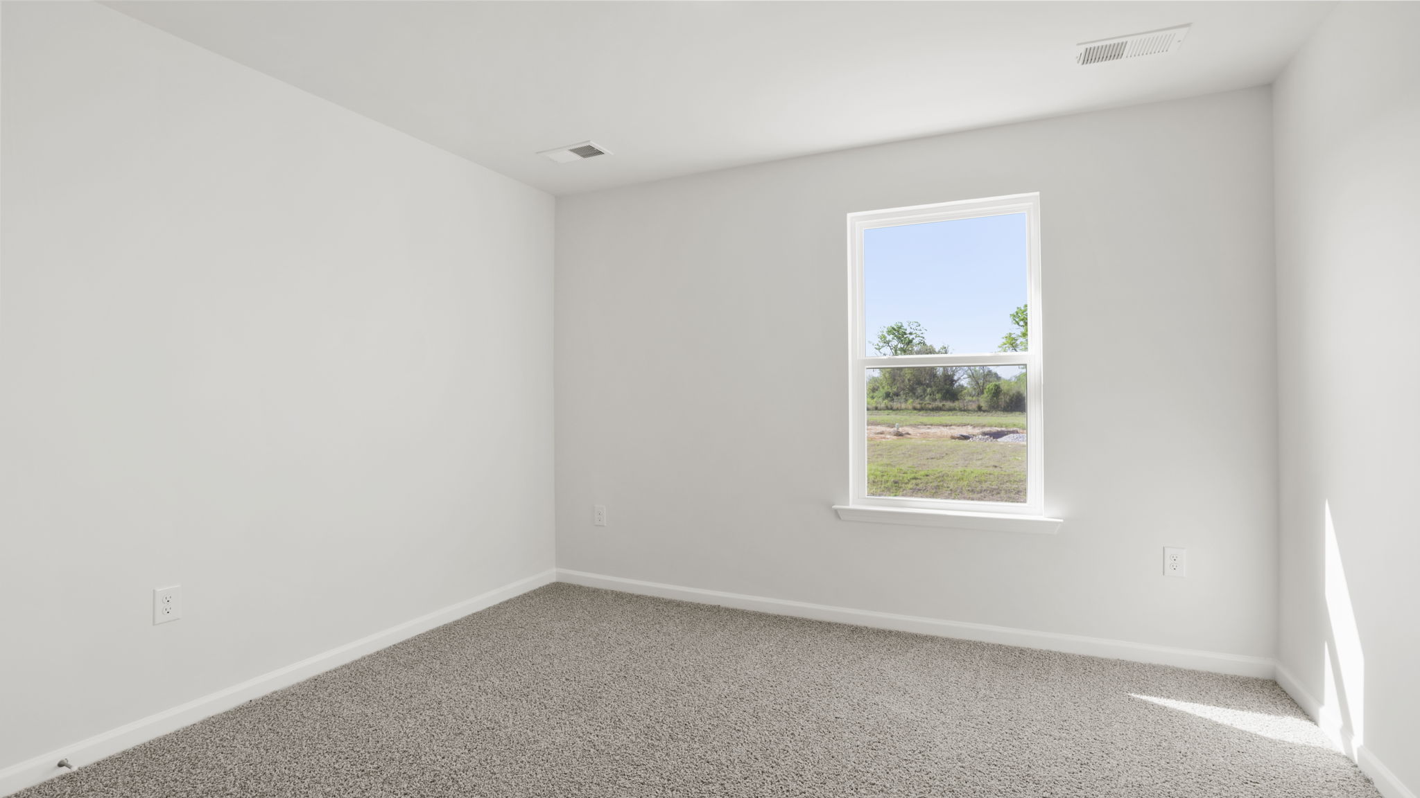 Bedroom with carpet and window.